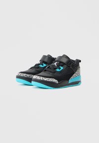 Pantofi sport negri cu accente turquoise, plasă texturată și o talpă intermediară gri cu pete. Au bretele Velcro și o talpă din cauciuc.