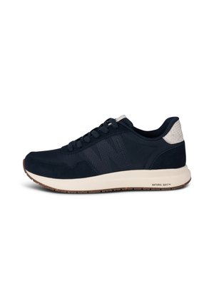 Navy blue athletic shoe with suede and mesh materials, featuring a rubber sole, contrasting white accents, and round laces.