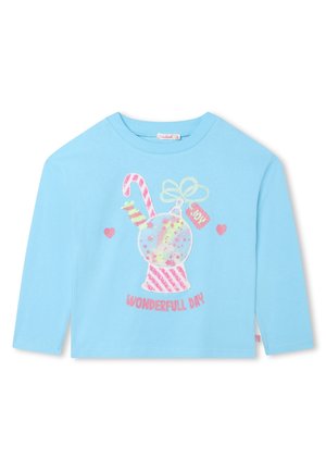Light blue long-sleeve shirt with candy-themed graphic, stars, hearts, and the text "WONDERFULL DAY" in pink glittery letters.
