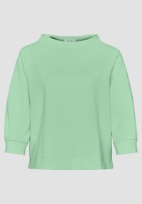 Chemise manches longues vert menthe avec col rond et poignets côtelés, présentée sur un fond uni gris clair.
