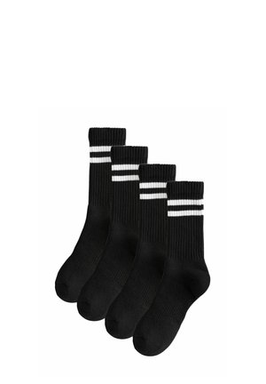 Black ribbed socks with three white stripes near the cuff. Four pairs displayed, featuring a soft texture and standard sock shape.