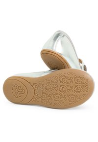 Metallic silver shoe with a rounded toe and rubber sole. The sole features an embossed floral pattern, providing grip and texture.