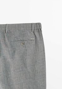 Pantaloni a quadri grigi con tasca posteriore con bottone, vita elastica e tessuto testurizzato con modelli a quadri variabili.