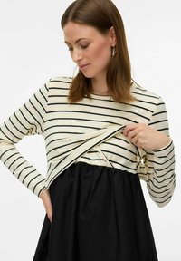 Svītrains garās piedurknes tops krēmkrāsā un melnā krāsā, ar savilktu melnu svārku. Iekļauj šķēru atvēršanu ērtai piekļuvei. Gluda auduma faktūra.