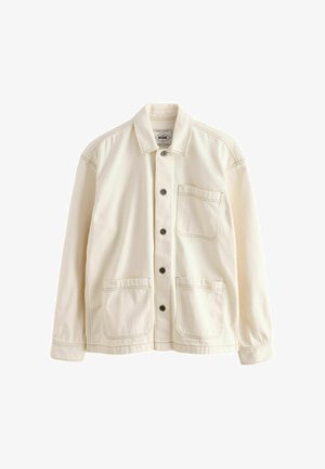 Svetlo béžová bunda vyrobená z plátna. Má zapínanie na gombíky, golier, dve predné vrecká a kontrastné švy. Klasický uvoľnený strih.