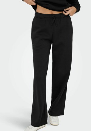 Pantaloni della tuta neri con vita elastica e cordino. Design a gamba svasata, realizzati in materiale morbido, senza motivi o dettagli distintivi.