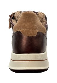 Baskets en cuir marron avec un talon en daim, semelle intermédiaire texturée blanche et détail de fermeture éclair. Doublure douce visible au niveau du talon.