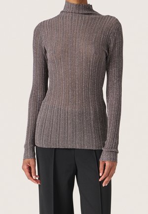 Eng anliegender, gerippter Rollkragenpullover mit langen Ärmeln in Metallic-Grau, getragen mit schwarzer Hose, dargestellt von den Schultern bis zur Hüfte.