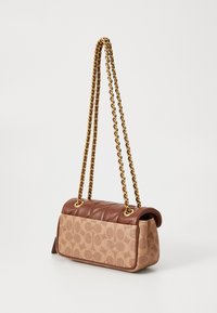 Brown leather and patterned canvas handbag with a quilted top, gold chain straps, and a rectangular shape. Features a smooth texture.