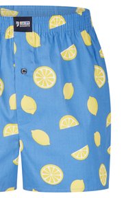 Blauwe stoffen shorts met een patroon van gele citroenen en citroenschijven, elastische tailleband en knopen sluiting.