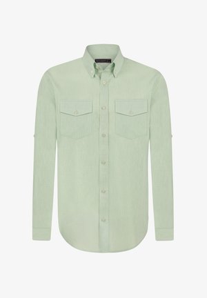 Heleda roheline pikakätine särk, millel on nööpidega krae, kaks rinna taskut ja ümar alläär; valmistatud tekstuuriga kangast.