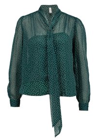 Blusa verde a pois realizzata in tessuto trasparente, con scollatura annodata, maniche lunghe a sbuffo e una vestibilità morbida. Decorata con pois bianchi.
