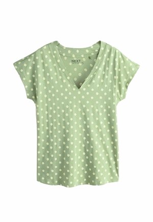 Heleroheline lühikeste varrukatega särk valgete täppidega ja V-kaelusega, tasapinnal valgel taustal.