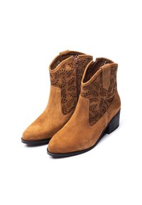 Tan suede ankle boots with a pointed toe, decorative cut-out detailing on sides, and a low block heel. Zip closure at the back.