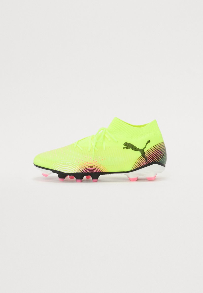Neon yellow soccer cleat with a knitted ankle collar, gradient black to pink accents, textured surface, and black Puma logo.