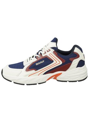 White and navy mesh sneaker with red and orange accents, textured panels, cushioned sole, and logo detailing on the side.