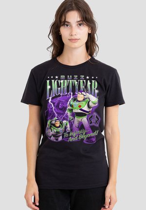 Young woman wearing black Buzz Lightyear graphic tee with purple lightning and "To Infinity and Beyond" text.