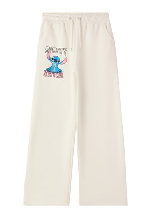 I pantaloni in felpa a gamba larga color crema presentano una vita elastica con cordoncino e una grafica di Stitch insieme al testo "SPORTY STITCH."