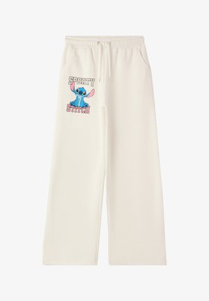 I pantaloni in felpa a gamba larga color crema presentano una vita elastica con cordoncino e una grafica di Stitch insieme al testo "SPORTY STITCH."