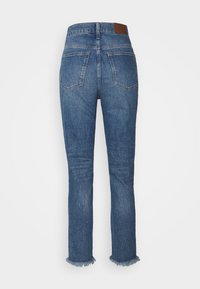 Denim jeans in a medium blue wash with a straight-leg fit, featuring a high waist, two back pockets, and a frayed hem. Brown leather accent patch.