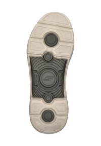 Black and white athletic shoe sole featuring circular grips, textured patterns, and a mid-section logo, with a primarily rubber material.
