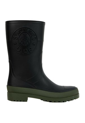 Botte de pluie en caoutchouc noir avec semelle texturée verte et logo Dior circulaire embossé sur la tige supérieure.