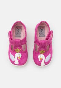 Pink fabric shoes with a Velcro strap, featuring a swan design with a gold crown and white wings, set on a white sole.