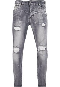 Jeans grigi sfumati con vestibilità slim, caratterizzati da strappi invecchiati e leggere sfumature sul tessuto, chiusura con bottone metallico e tasche anteriori tradizionali.