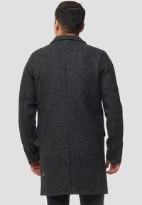 Abrigo de lana gris oscuro con acabado texturizado, que presenta una abertura trasera, puños con botones y una silueta entallada.