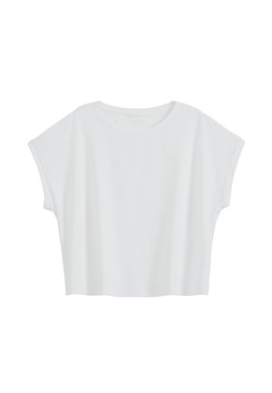 Hvid kortærmet crop top med rund halsudskæring og løs pasform, vist på en ensfarvet baggrund.