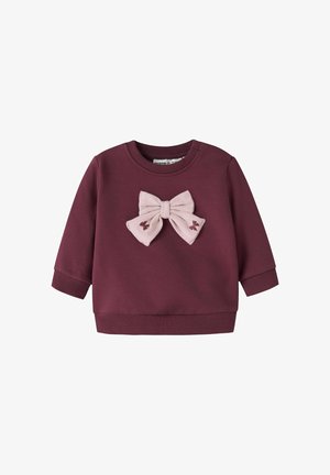 Bordeaux sweatshirt met een roze stoffen strik aan de voorkant. Lange mouwen, geribde manchetten en zoom, zachte textuur en geborduurde details.