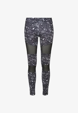 svarte leggings med et kosmisk mønster av stjerner og planeter, med mesh-segmenter på lårene og leggene for ekstra tekstur og stil.