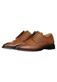 Brown leather lace-up shoes featuring a brogue design, rounded toe, and textured accents on the upper. Black rubber sole.
