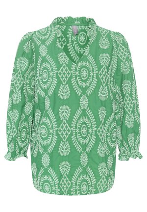 Zöld blúz fehér virágos és geometriai mintákkal. Ráncos nyakkivágással és puffos ujjakkal rendelkezik, könnyű anyagból készült.