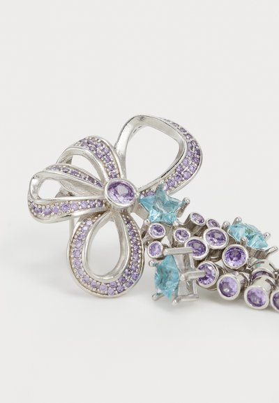 Silver brooch in the shape of a flower, featuring purple gemstones and aqua blue accents, with intricate detailing and a glossy finish.
