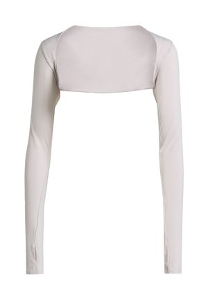 Bluzka z długim rękawem z jasnobeżowej tkaniny, z krótkim tyłem i gładką teksturą. Dopasowana, z bocznymi rozcięciami przy nadgarstkach.