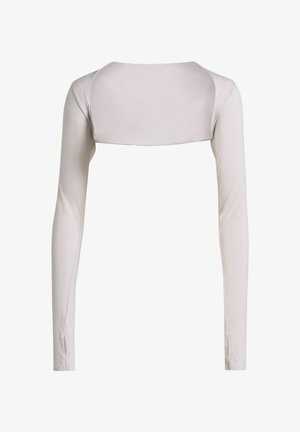 Long-sleeve top in light beige fabric, featuring a cropped back and smooth texture. Close-fitting with side openings at the wrists.