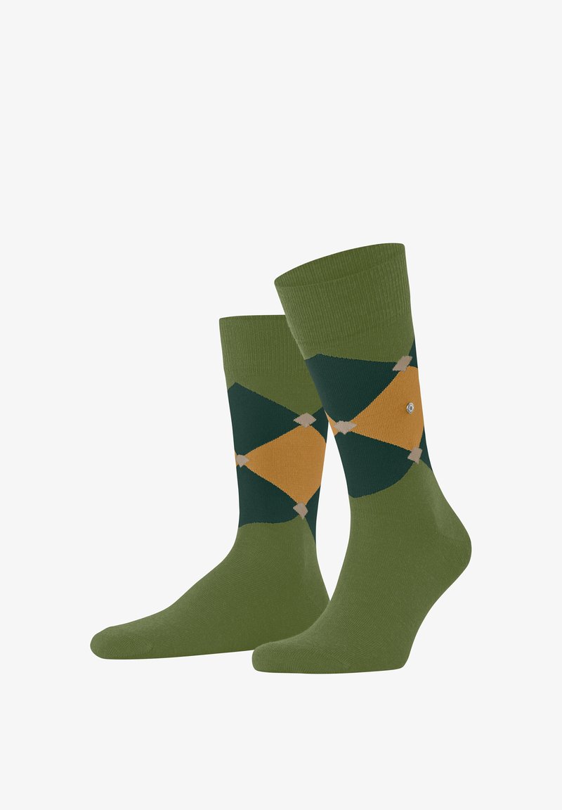 Par de calcetines verdes con patrón romboidal argyle en tonos verde oscuro, mostaza y beige, mostrados uno al lado del otro.