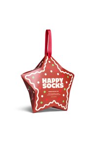 Red star-shaped gift box with a gingerbread design, white icing accents, and colorful dot details. Contains four pairs of socks.