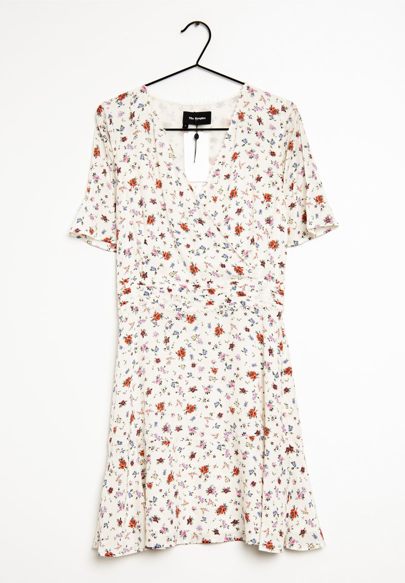 Valkoinen kukkamekko lyhyillä hihoilla, jossa on V-pääntie ja kerättynä vyötärö. Pieniä monivärisiä kukkia punaisena, sinisenä ja purppurana.