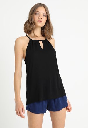 Black sleeveless top with a keyhole cutout, gathered neckline, and a flowy design. Paired with blue shorts, creating a layered look.