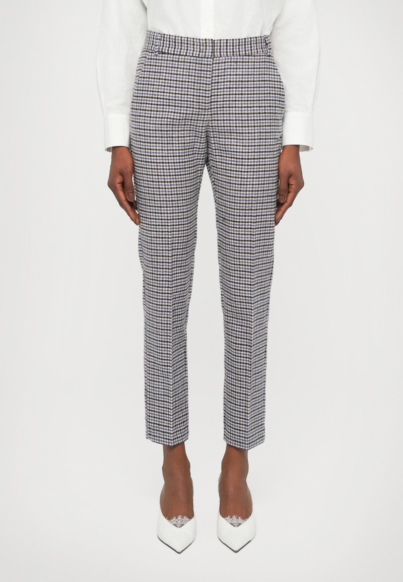 Checked trousers in a light fabric, featuring a grid pattern of blues, browns, and whites, with a tapered fit and flat front.