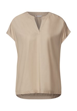 Beige kortärmad blus med V-ringning, tillverkad av mjukt tyg. Har en avslappnad passform och en böjd nederkant för en bekväm look.
