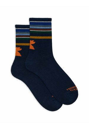 Calze blu navy con strisce multicolori in cima, presentano un silhouette di animale arancione e "TENDING" in arancione sulla punta. Morbido, tessuto a costine.