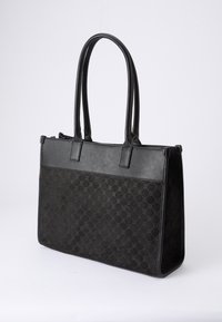 Black tote bag made of leather and fabric, featuring a textured pattern. It has two long handles and a structured shape. Zipper closure on top.