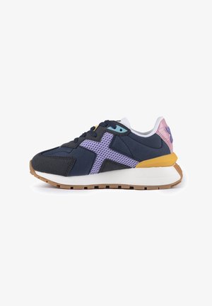 Navy and purple sneaker with mesh and suede materials, featuring a white midsole, gum outsole, and pastel accents on the heel and tongue.