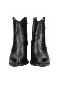 Bottines en cuir noir avec une finition lisse, ornées de couture décorative et d'une fermeture éclair de chaque côté. Semelle plate et talon pointu.