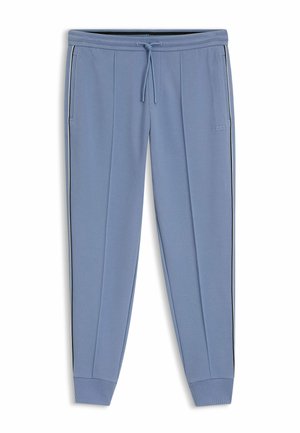 Pantaloni da jogging azzurri con tasche laterali, strisce laterali bianche e nere, polsini a coste e cintura con coulisse, con un piccolo logo.