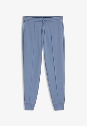 Lichtblauwe joggingbroek met zijzakken, zwart-witte strepen aan de zijkant, geribbelde boorden en een tailleband met trekkoord, voorzien van een klein logo.