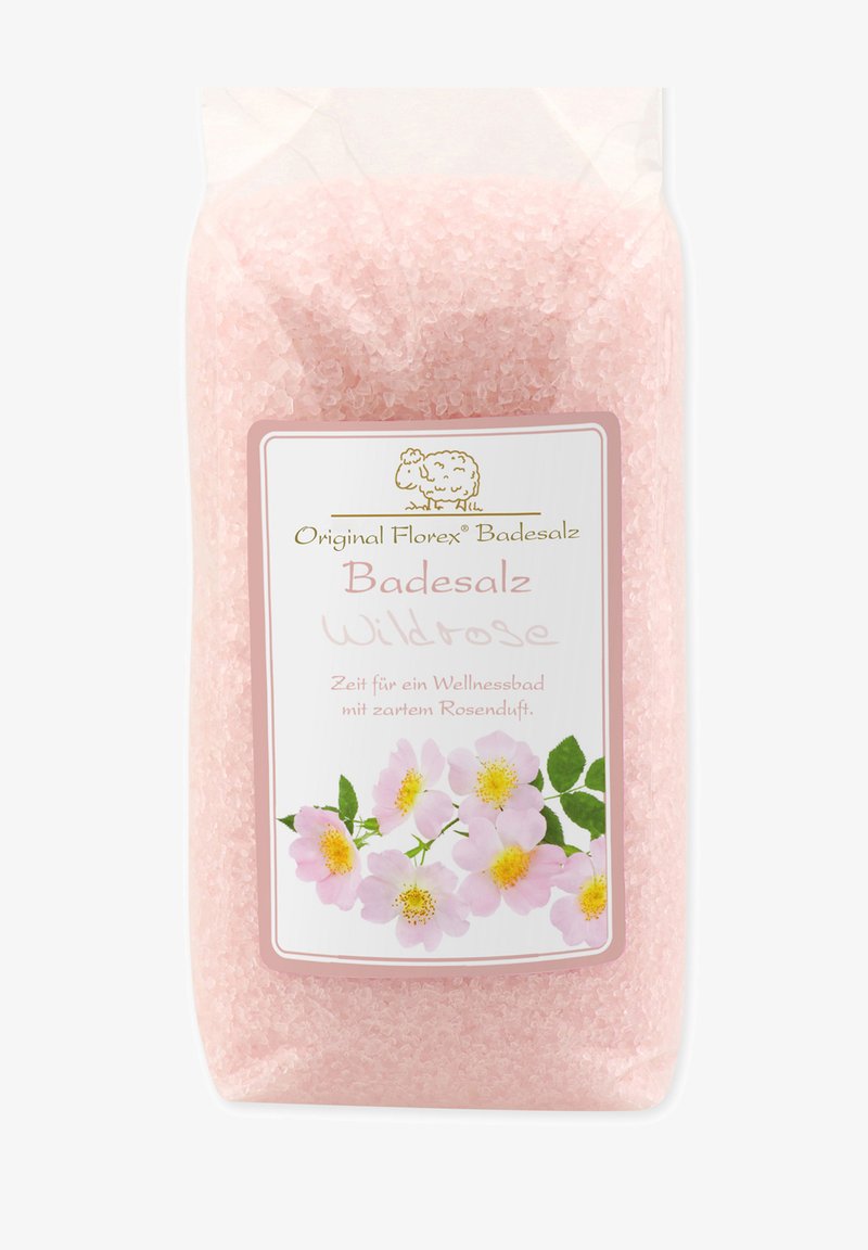 Pink bath salt in a transparent bag, featuring a white label with floral design and gold accents, labeled "Badesalz Wildrose."